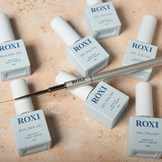Roxi 12 mm Precision Brush alongside Roxi Builder Gels and Gel Polish