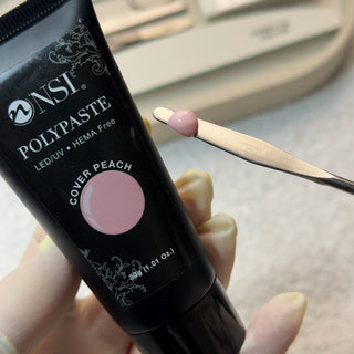 NSI Polypaste LED/UV HEMA Free Cover Peach nail polish with a small amount on a Spatula.