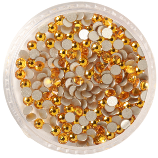 Container of gold round sequins on a white background