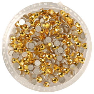 Round container filled with gold sequins on a white background
