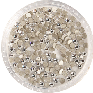 Clear container filled with silver and gold round sequins on a white background