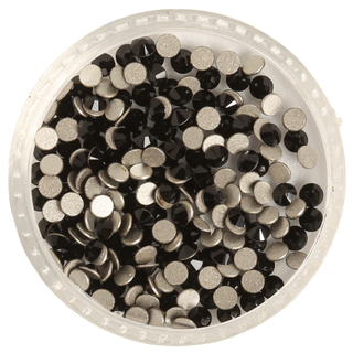 Clear container filled with black rhinestones on a white background