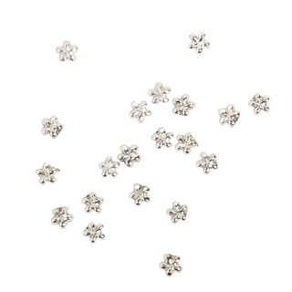 Silver flower-shaped rhinestone components on a white background