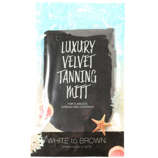 Black tanning mitt in packaging with text on a white background